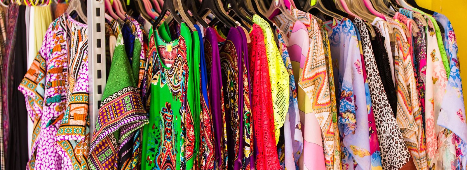A colourful collection of printed clothing on display